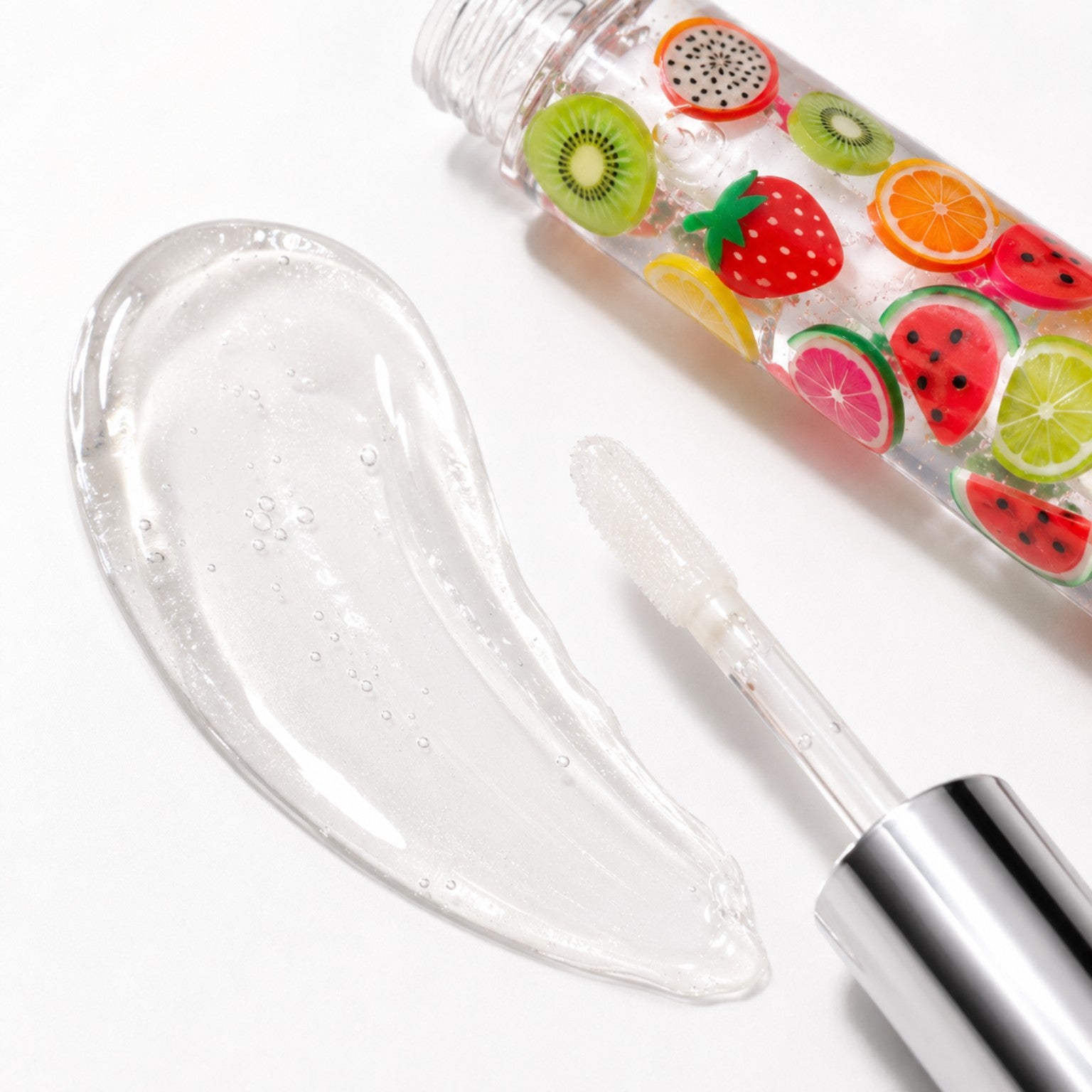 Clear high-shine Fruity Drip lip gloss texture with wand applicator