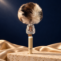 Cream pen with a brown-and-cream pom-pom and clear backpack-shaped Labubu character charm