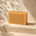PL3 Oatmeal Milk and Honey cold process soap bar on a warm stone pedestal