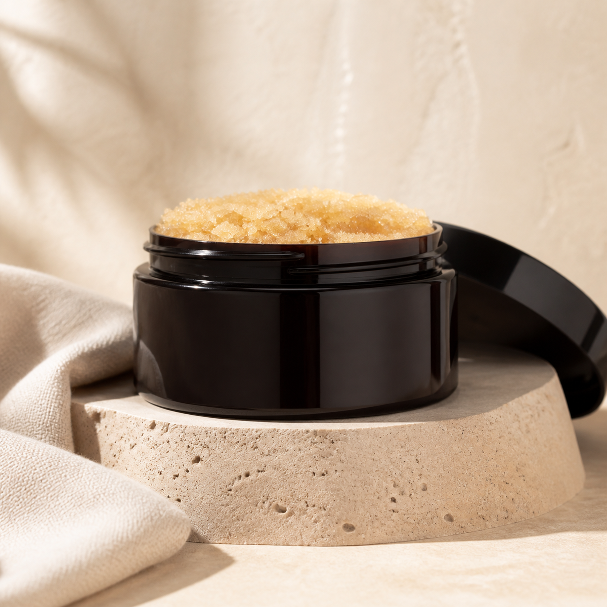 Oatmeal Milk and Honey Brown Sugar Scrub on a travertine pedestal
